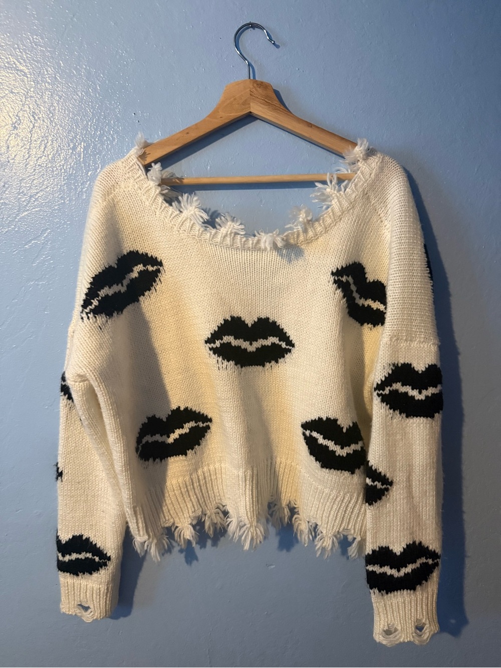 Miracle Cream Off-the-Shoulder Sweater with Black Lip Motifs